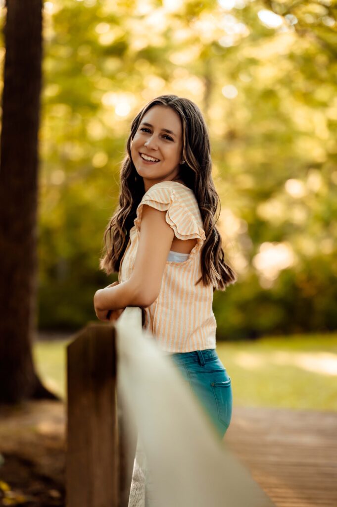 JMR_0750-Edit | Two Wild Souls Photography High school senior leaning on the bridge rail at Van Hoosen Farm in Rochester, Michigan
