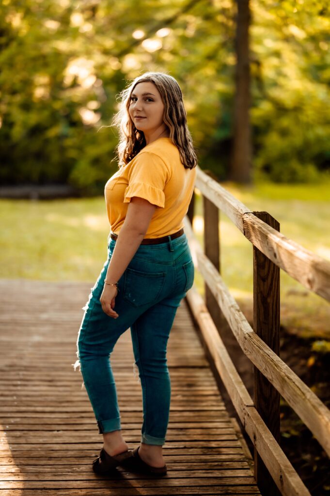 JMR_0783-Edit | Two Wild Souls Photography Senior photo on the wooden footbridge over Stoney Creek at Van Hoosen Farm, Rochester Hills