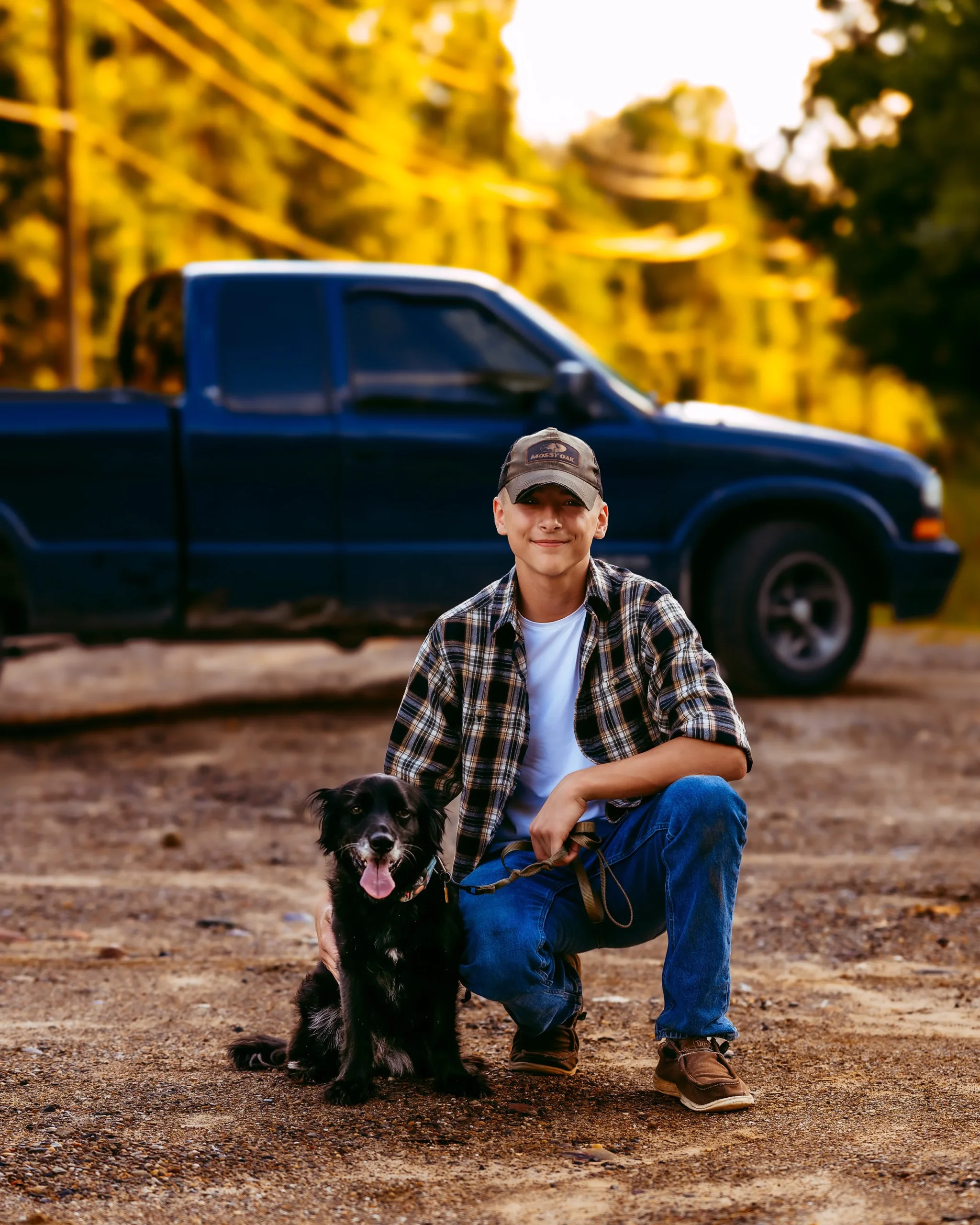 Man posed with dog in front of truck at high school senior photography session with Two Wild Souls Photography