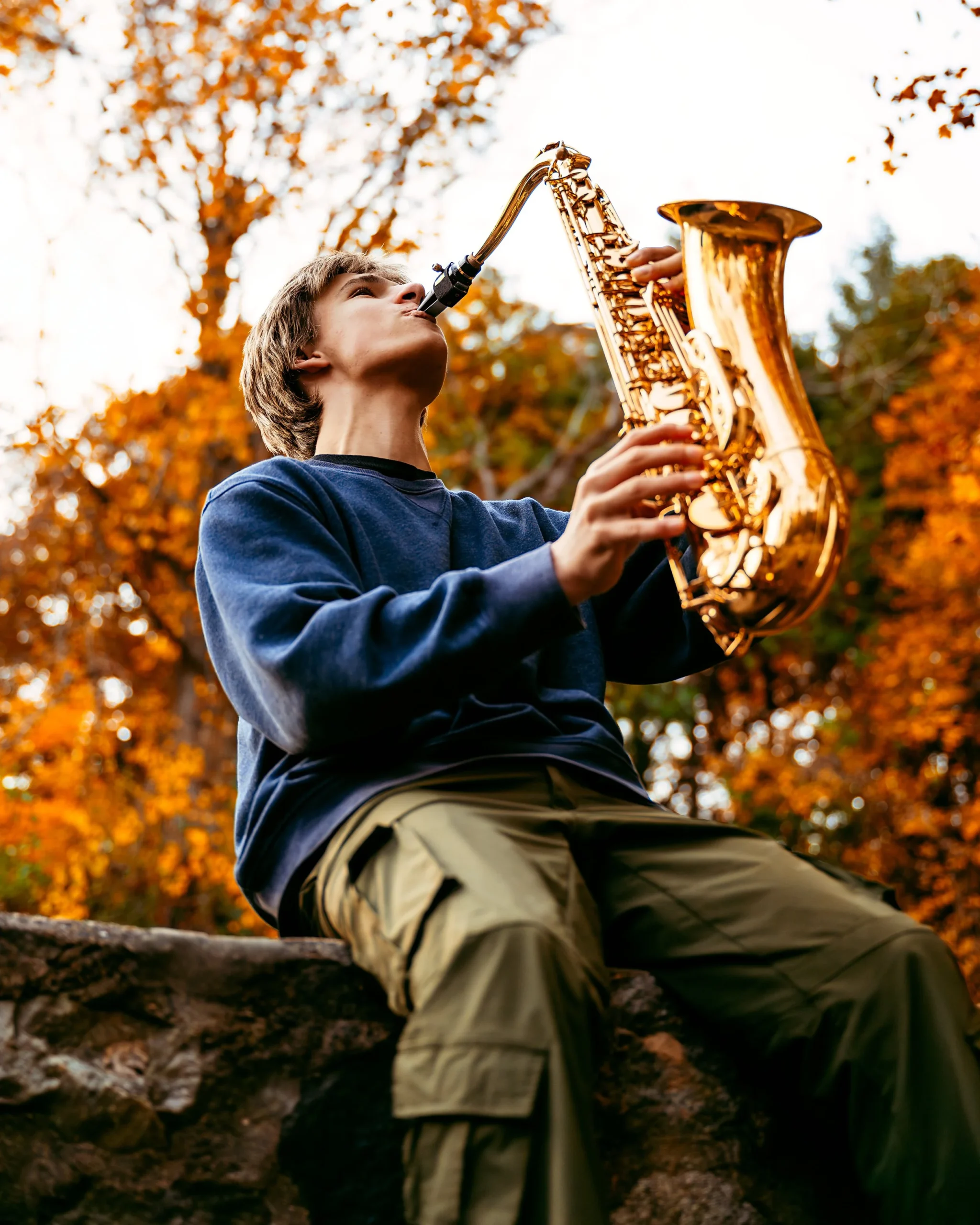 Man playing his saxophone at high school senior photography session with Two Wild Souls Photography