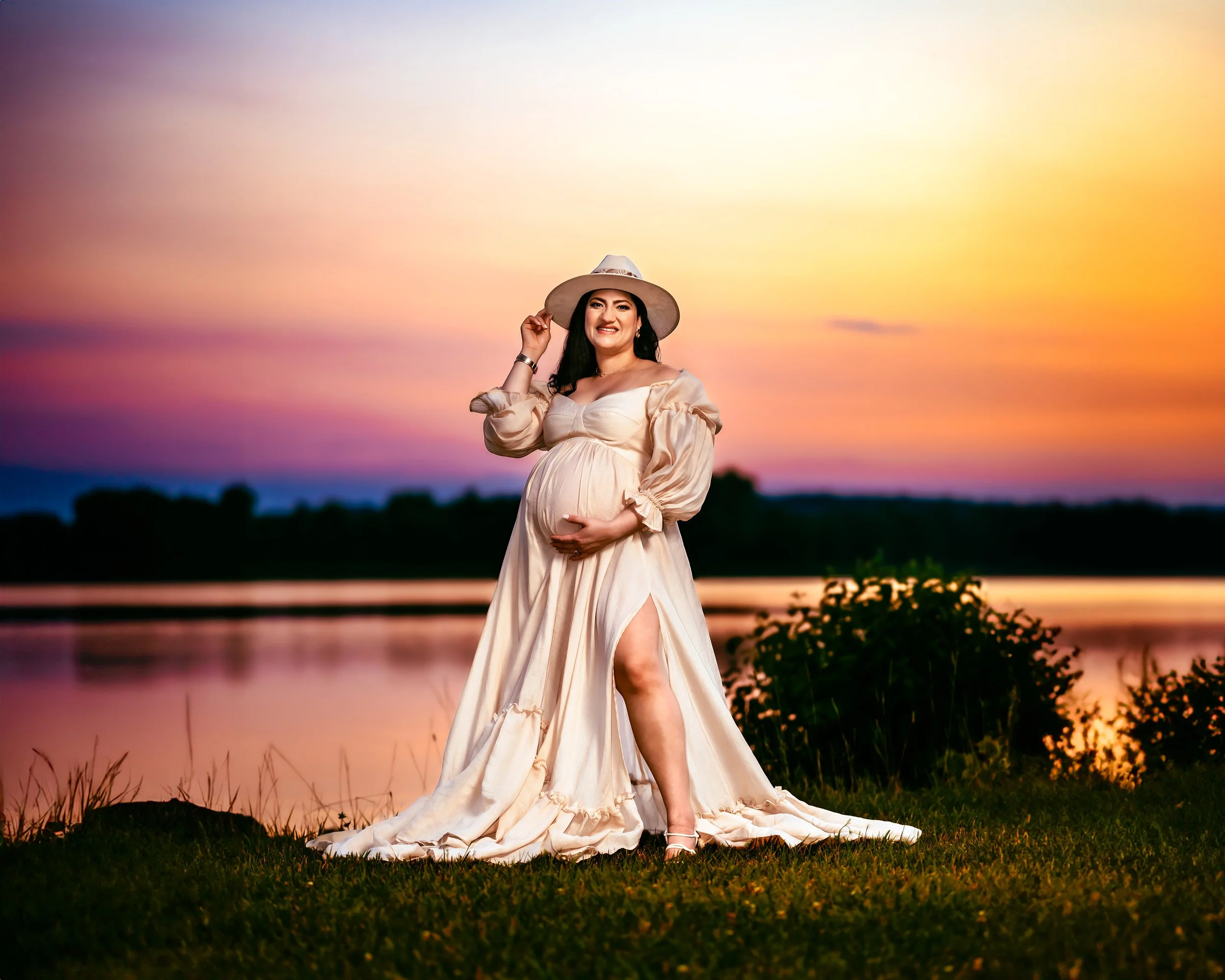 Mother holding her baby bump at a Maternity Photography Session during sunset with Two Wild Souls Photography