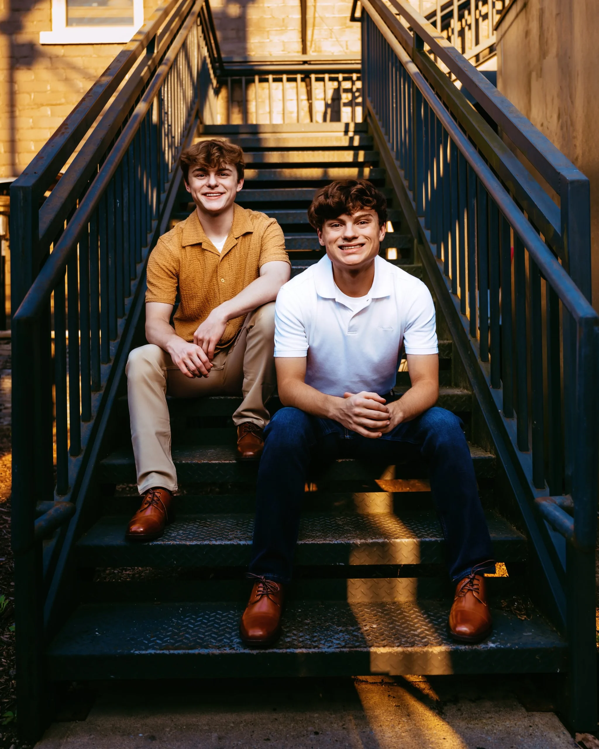 Twin senior male's on stairs in an alley at High school senior photography session with Two Wild Souls Photography